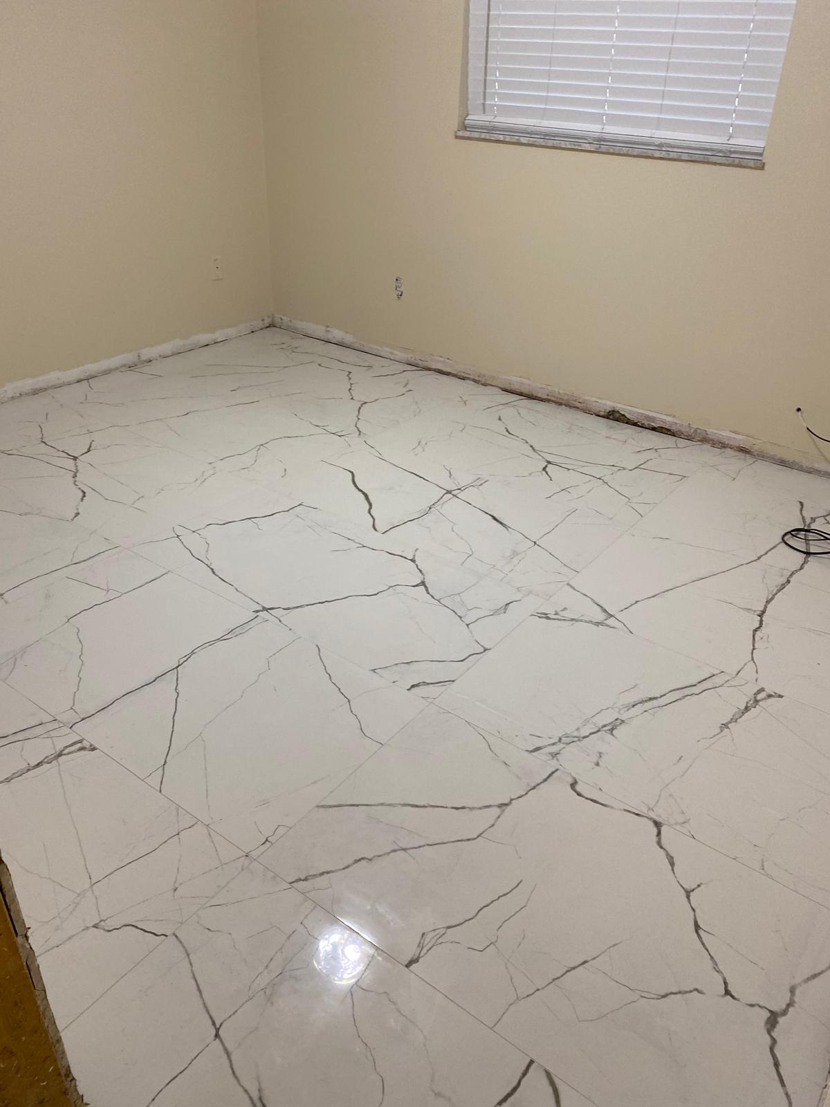 Large-format porcelain floor set on the diagonal in a prepared room